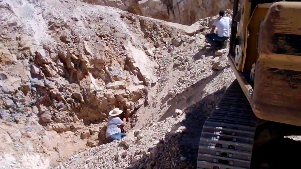  Dean Otteson, owner of multiple turquoise mining claims in the Royston mining district, picks away at a turquoise vein.